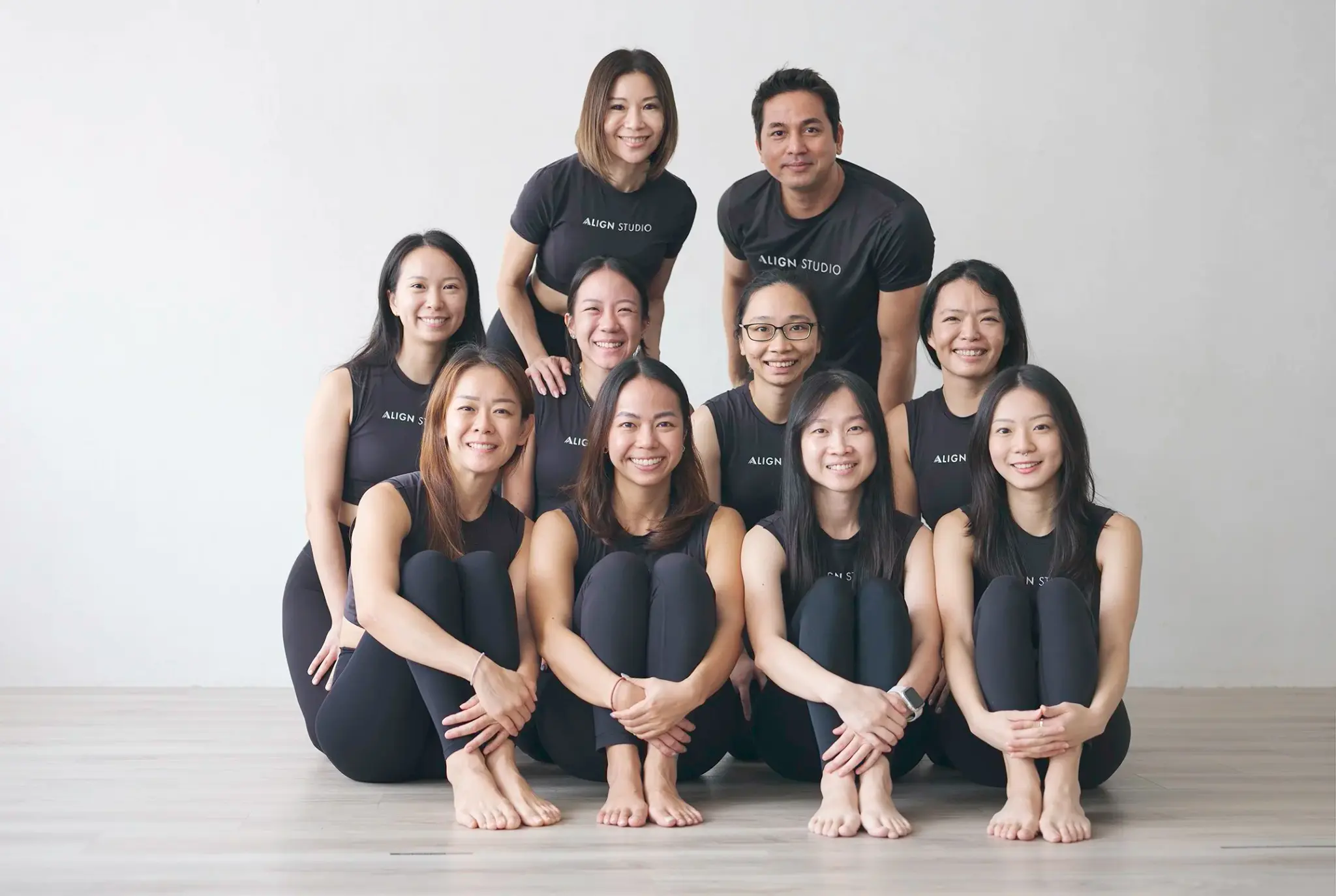 The Align Studio group at the 2024 teacher-training graduation, in black Align Studio T-shirts on the studio floor